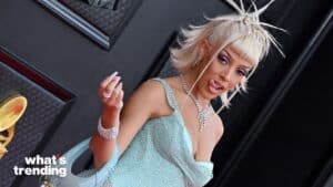 Cardi B in a sparkling light blue dress with diamond jewelry and a unique braided hairstyle at a red carpet event