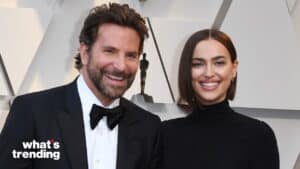 Bradley Cooper and Irina Shayk smiling at a formal event with an Oscar statue backdrop