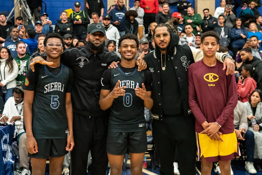 Bryce James, LeBron James, Bronny James, Carmelo Anthony and Kiyan Anthony pose together at the Sierra Canyon vs Christ The King boys basketball game at Sierra Canyon High School on December 12, 2022 in Chatsworth, California