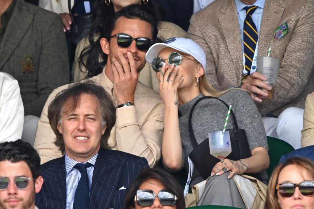 Jonathan Bailey and Ariana Grande watch Carlos Alcaraz vs Novak Djokovic in the Wimbledon 2023 men's final on Centre Court during day fourteen of the Wimbledon Tennis Championships at the All England Lawn Tennis and Croquet Club on July 16, 2023 in London, England. (Photo by Karwai Tang/WireImage)