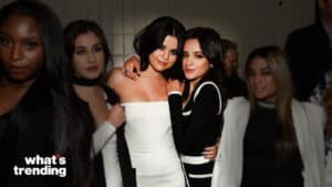 Selena Gomez and Camila Cabello posing together at an event with other people in the background.