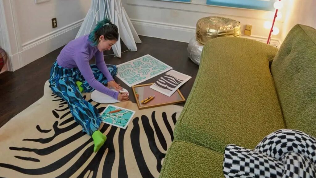 Tay Beep Boop crafts on her living room floor.