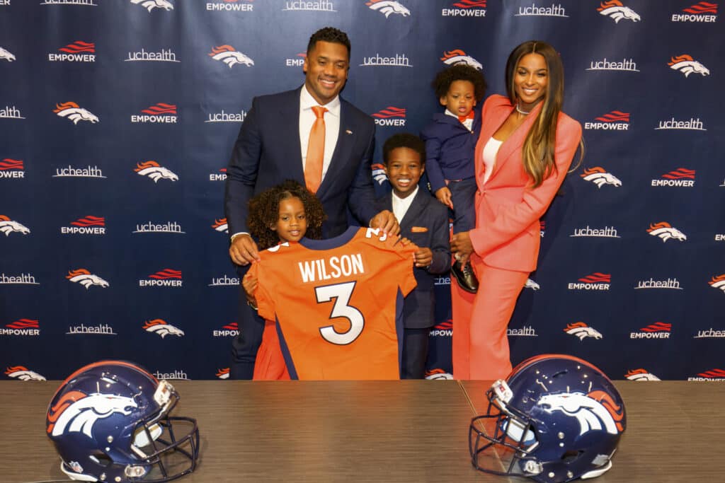 Quarterback Russell Wilson #3 of the Denver Broncos poses with his family (L-R), Sienna, Future, Win and Ciara following an introductory press conference at UCHealth Training Center on March 16, 2022 in Englewood, Colorado.
