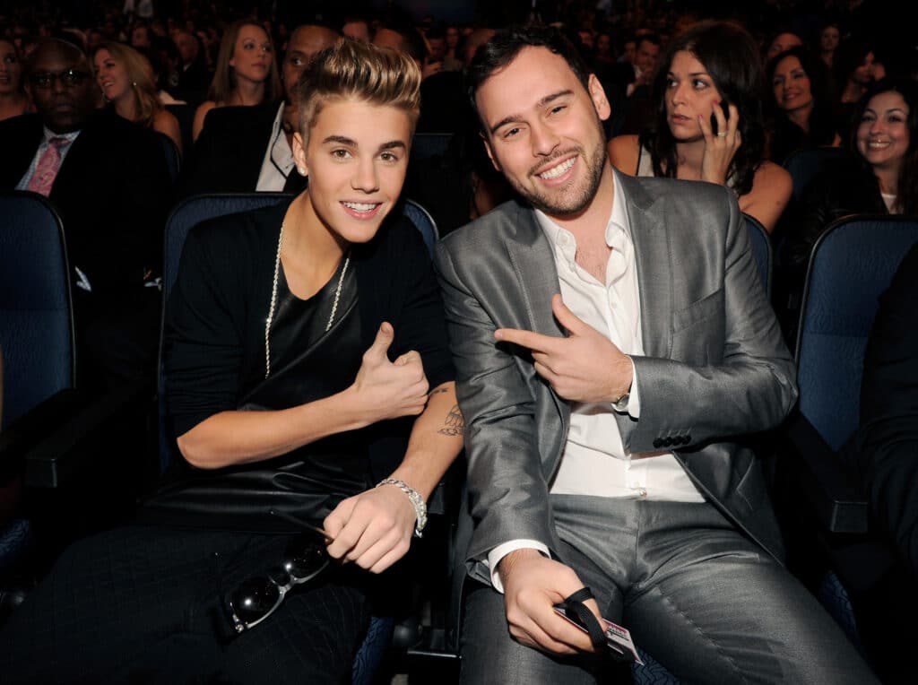 Singer Justin Bieber (L) and manager Scoot Braun pose in the audience at the 40th American Music Awards held at Nokia Theatre L.A. Live on November 18, 2012 in Los Angeles, California. 