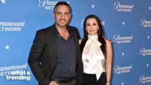 Man and woman posing together on Paramount Network blue backdrop at event