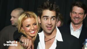 Britney Spears and Colin Farrell smiling and posing together at an event with a man smiling in the background