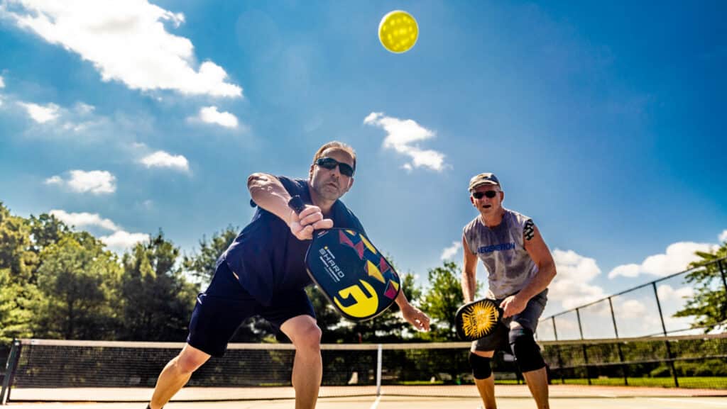 John Merrill of South Setauket, New York and Jerry Byrne of Northport, New York play pickle ball.