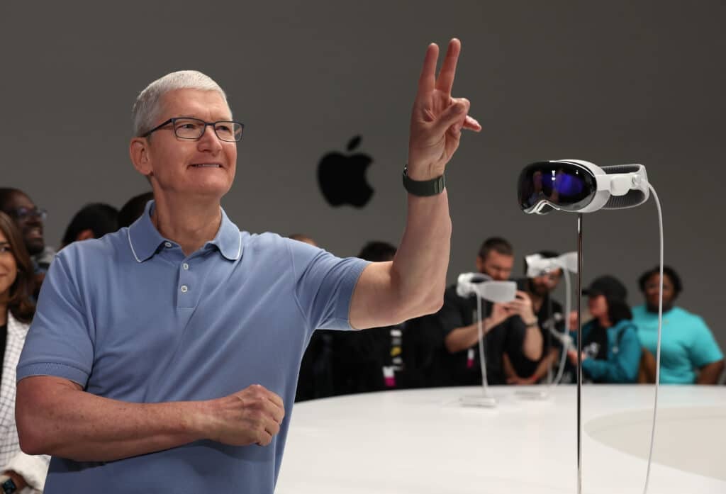 Apple CEO Tim Cook stands next to the new Apple Vision Pro headset is displayed during the Apple Worldwide Developers Conference on June 05, 2023 in Cupertino, California. Apple CEO Tim Cook kicked off the annual WWDC23 developer conference with the announcement of the new Apple Vision Pro mixed reality headset.
