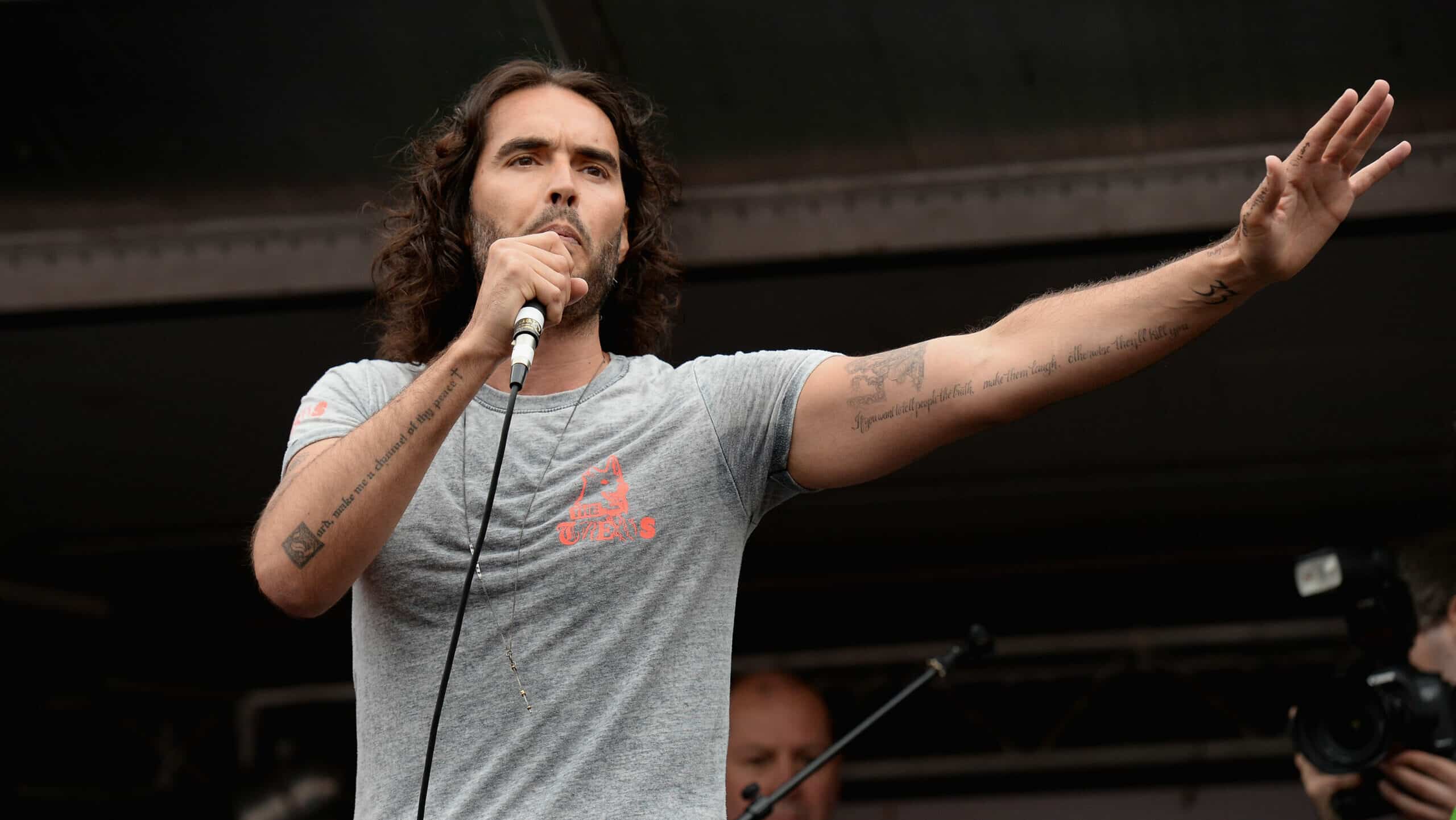 Comedian Russell Brand speaks to thousands of demonstrators gathered in Parliament Square to protest against austerity and spending cuts on June 20, 2015 in London, England. Thousands of people gathered to march from the City of London to Westminster, where they listened to addresses from singer Charlotte Church and comedian Russell Brand as well as Len McCluskey, general secretary of Unite and Sinn Fein's Martin McGuinness.