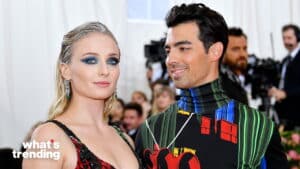 Sophie Turner and Joe Jonas posing at a formal event with photographers in the background.