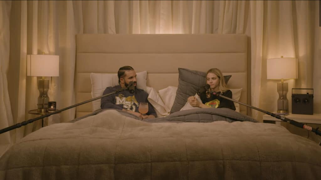 Bobbi Althoff and Drake sit in a bed for an episode of 'The Really Good Podcast'