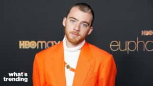 Musician and actor Finneas O'Connell wearing an orange blazer at an HBO Max Euphoria event.