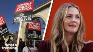 Writers Guild of America members holding strike signs outside Paramount Studios with a woman speaking against an orange background