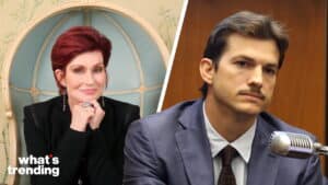 Sharon Osbourne smiling in black outfit and a man with mustache in suit speaking into a microphone