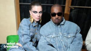 Julia Fox and Kanye West wearing denim jackets and posing together indoors