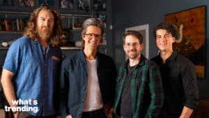 The Try Guys standing together smiling in a room with bookshelves and artwork behind them