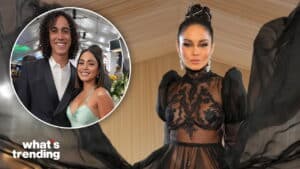 Vanessa Hudgens in a sheer black lace gown with puff sleeves and a high bun hairstyle.