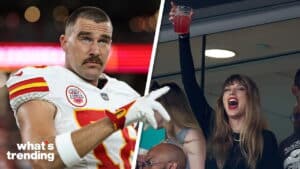 Kansas City Chiefs player Travis Kelce pointing, Taylor Swift cheering with a drink raised in a stadium box