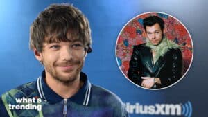 Louis Tomlinson smiling during a SiriusXM interview with an inset photo of Harry Styles in a black leather jacket and green feather scarf.