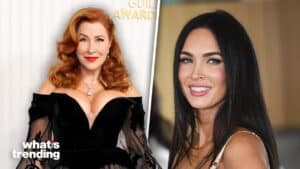 Two women, one with red hair in a black off-shoulder dress and the other with long black hair smiling in a beige top