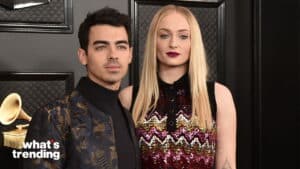 Joe Jonas and Sophie Turner posing at an event with a Grammy trophy in the background