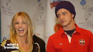 Britney Spears laughing next to Justin Timberlake wearing a purple beanie at a Britney Spears Foundation event