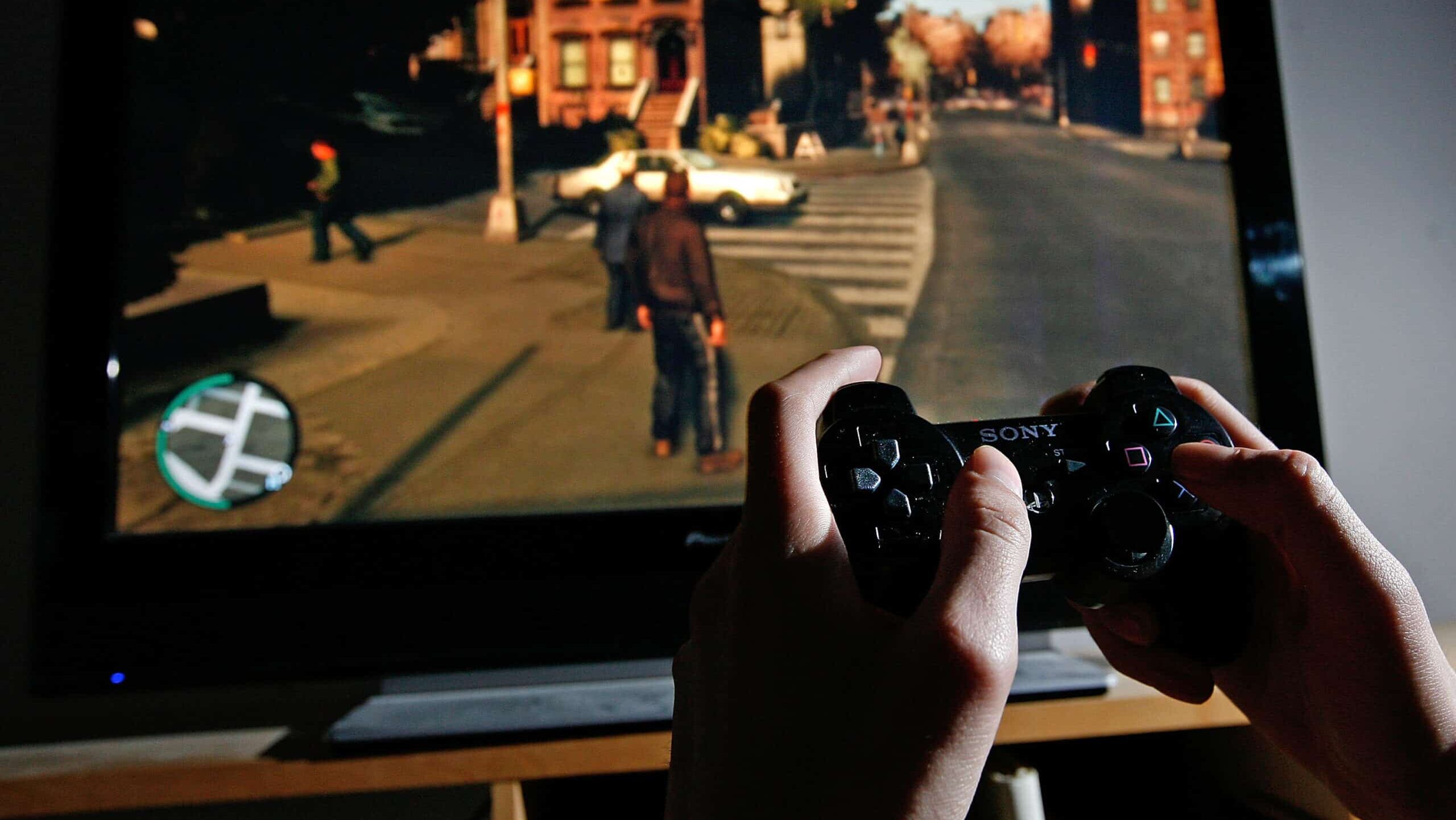 LONDON - APRIL 29: A young man plays Grand Theft Auto IV on the game's day of release on April 29, 2008 in London, England. The game designed for the Playstation 3 was in high demand and sold out in stores across London during its first day of sale.