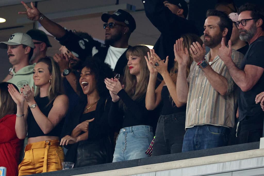 Singer Taylor Swift, Actor Ryan Reynolds and Actor Hugh Jackman cheer prior to the game between the Kansas City Chiefs and the New York Jets at MetLife Stadium on October 01, 2023 in East Rutherford, New Jersey.