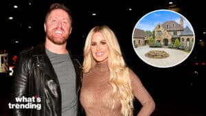 Couple posing at night with inset of large stone house under blue sky
