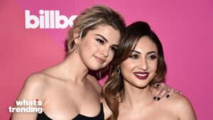 Selena Gomez and Francia Raisa posing together at a Billboard event with a pink background.