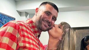 Taylor Swift kisses Travis Kelce on the cheek after Chiefs Game.