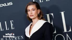 Hailey Bieber wearing a black and white outfit at an ELLE event with Lexus and Ralph Lauren branding in the background