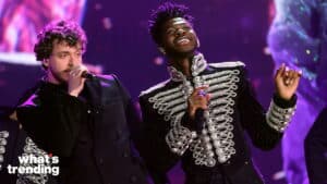 Jack Harlow and Lil Nas X performing on stage in embellished black jackets
