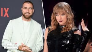 Man in white suit smiling next to Taylor Swift in black sequined dress with dark lipstick on stage