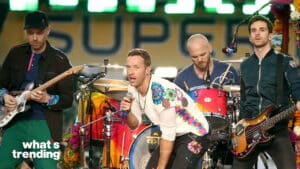 Coldplay performing live on stage with colorful instruments and outfits