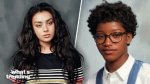 Two young women posing, one with long dark hair in a striped shirt, the other with short curly hair and glasses in a white shirt and denim overalls