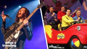 Musician passionately playing electric guitar and The Wiggles members sitting in a red car on stage