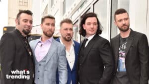 Backstreet Boys posing together outdoors in suits and casual attire