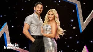 Smiling man and woman in silver outfits posing against a starry black background with "what's trending" text.