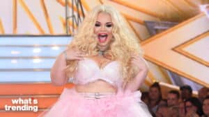 Trisha Paytas smiling in a pink tulle skirt and white bra on a stage with "what's trending" text.