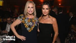 Kathy Hilton and Kyle Richards posing together at a formal event with dim lighting.