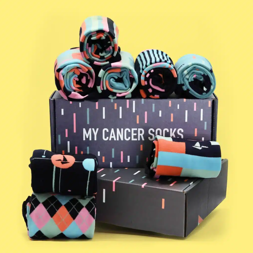 Hank Green's sock collection sits in a box labeled 'My Cancer Socks.'