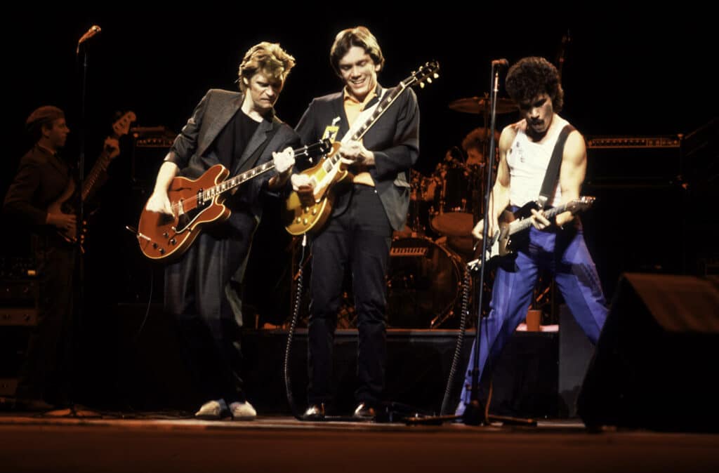 American musicians Darryl Hall (left), GE Smith (center), and John Oates perform as Hall & Oates at the Chicago Stadium, Chicago, Illinois, November 5, 1981.