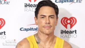 Manny Montana wearing a yellow tank top at an iHeartRadio event with Capital One branding in the background