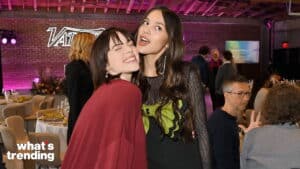 Billie Eilish and Olivia Rodrigo posing together at a social event with a "what's trending" logo visible
