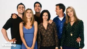 Cast of Friends TV show smiling together against a white background