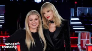 Kelly Clarkson and Taylor Swift posing together on the set of The Voice with red chairs in the background