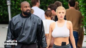 Kanye West and Julia Fox walking hand in hand outdoors with casual clothing