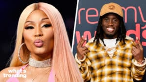Nicki Minaj with pink hair and large hoop earrings, and a man in a yellow plaid jacket and tan Timberland cap smiling and posing.