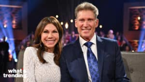 Two smiling people sitting on a couch in a studio with "what's trending" text in the corner